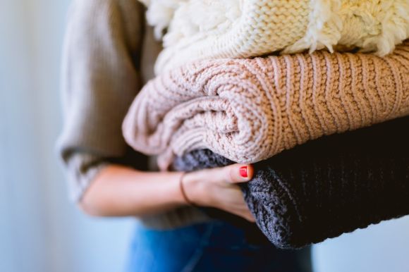 Blankets - person holding knitted textiles