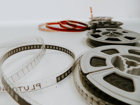 Films - four reel films lying on white table