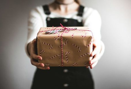 Gift - person showing brown gift box