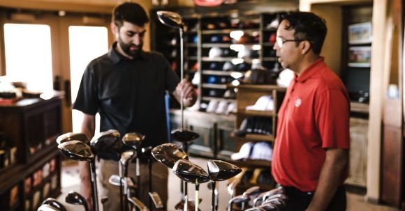 Golf Clubs - Man Standing Beside Man Holding Gray Golf Club