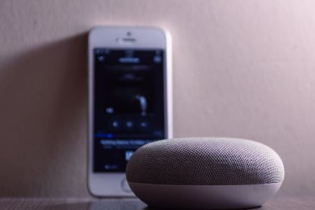 Smart Speaker - Gray Google Home Mini Beside Silver Iphone 5s