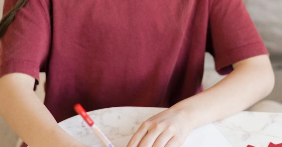 Kids DIY Projects - A Young Girl in Red Shirt Writing on Paper