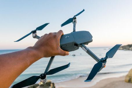 Drone Models - Person Holding Gray and Black Quadcopter Drone