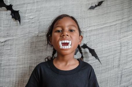 Teething Toys - Young girl with toy teeth in mouth